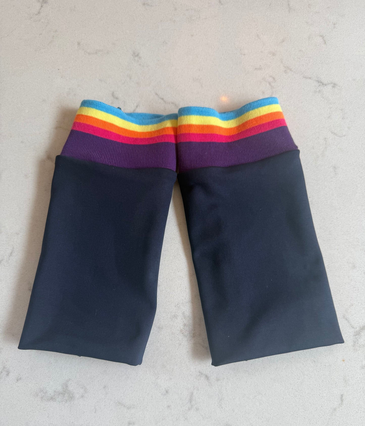Navy cuffs with multicoloured stripes.